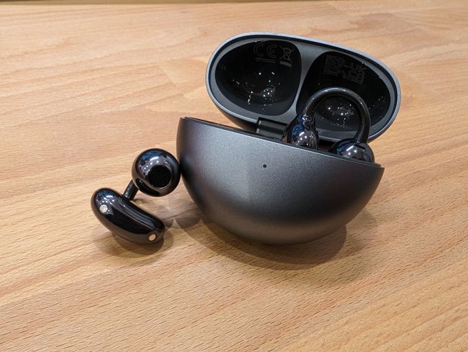 a Huawei FreeClip earbud and its case